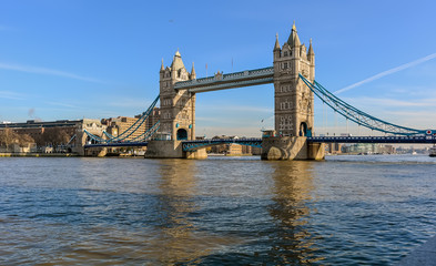 Fototapeta na wymiar Tower Bridge against the winter blue sky. The bascule and suspension bridge crosses the River Thames and has become an iconic symbol of London.