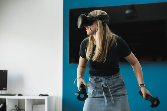 Blond girl playing VR game
