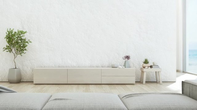 Sea view living room of luxury summer beach house with TV stand and wooden cabinet. Empty rough white concrete wall background in vacation home or holiday villa. Hotel interior 3d illustration.
