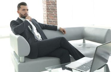 businessman sitting at a coffee table in the lobby