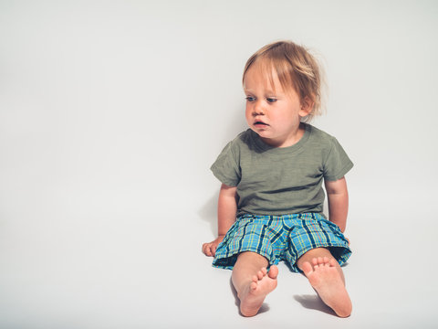 Cute little toddler boy posing on white background