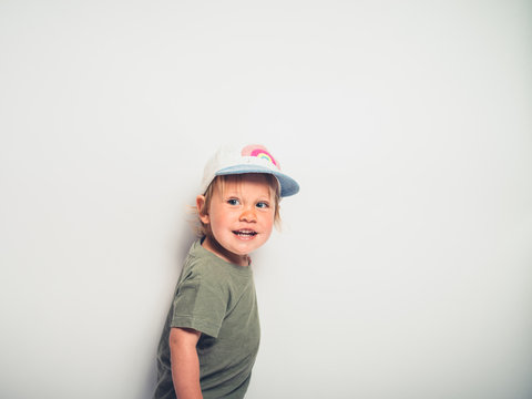Cute little boy with hat posing on white
