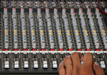 Channel Mixer for sound audio with hand. Human hand and mixing console for electro acoustics.