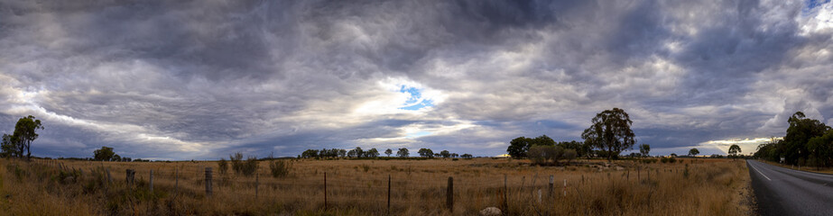 Last rays of sunlight over paddocks and fields on a chilly winters evening in Stanthorpe, Queensland, Australia