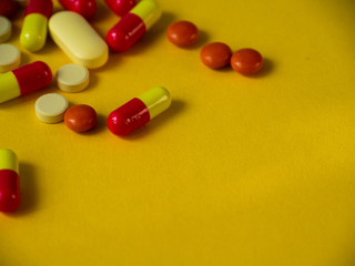 Tablets on a yellow background. Medicines.