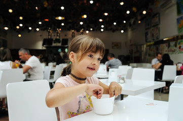 The girl is eating  ice cream.