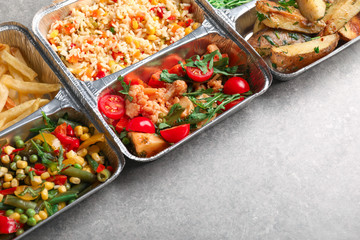 Food delivery containers with different meals on light table
