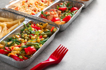 Food delivery containers with different meals on light table