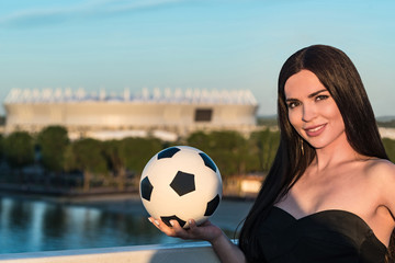 Pretty young model poses with football in Russia