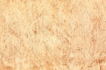 Fototapeta premium Aged beige plaster wall texture with rough surface and cracks, rustic background for design and decoration, this distressed material offers a vintage aesthetic for design and decoration projects