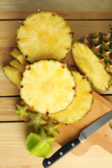 Composition with ripe fresh pineapple on wooden table