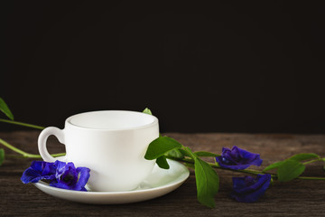 Healthy water Pea Flowers juice placed on the old wood background.