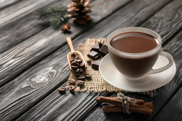 Cup of tasty hot chocolate on dark wooden table