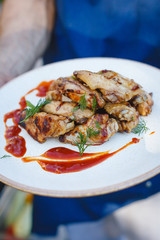 Chicken skewers on a plate with sauce