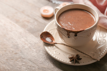 Cup of tasty hot chocolate on wooden table