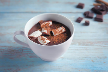Cup of hot chocolate with marshmallow on wooden table