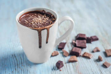 Cup of tasty hot chocolate on wooden background