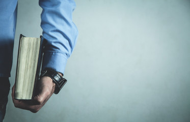 Caucasian man showing Holy Bible.