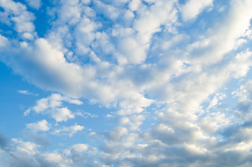 White clouds on a blue sky background.