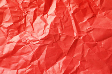 Obraz premium Vibrant red crumpled paper texture background with abstract folds and creases, rough surface detail for creative design, material