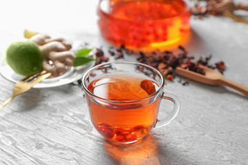 Glass cup of hot aromatic tea on table