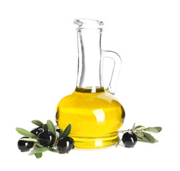 Fresh olive oil in jug and black olives on white background