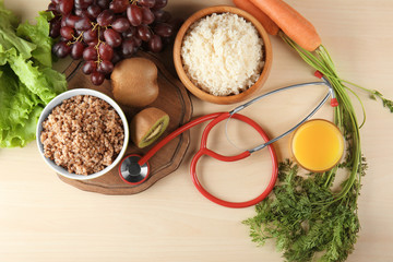 Healthy food with stethoscope on wooden table