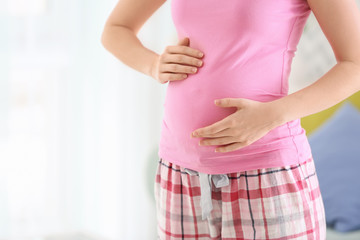 Morning of beautiful young pregnant woman at home, closeup