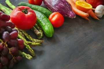 Various fruits and vegetables on grey background. Healthy food concept