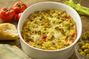 vegetable casserole with tomatoes and olives on a bread basis