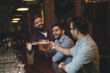 The guys in the pub are drinking beer