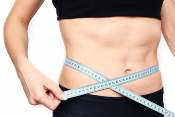 Slim Female Measuring her thin waist with a tape measure. Unrecognizable person.Diet and weight loss concept.