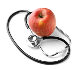 Stethoscope with apple on white background. Health care concept