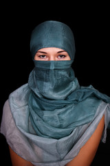 Naklejka premium Portrait of a young woman wearing hijab on black background.