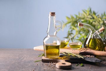 Beautiful composition with olive oil on table against light background