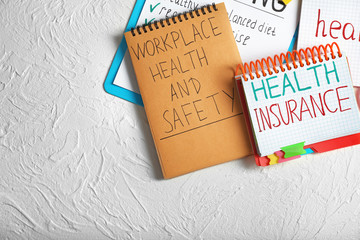 Inscriptions about health written in notebooks on white textured background