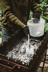 Cleaning the metal forged brazier in the yard