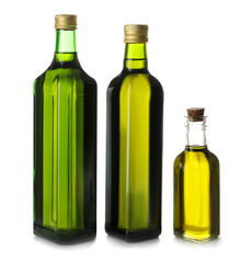 Glass bottles with olive oil on white background