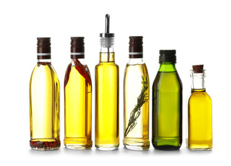 Glass bottles with olive oil on white background