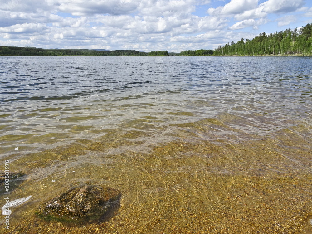 Wall mural summer landscape: blue lake on a sunny day and sky with feathery clouds