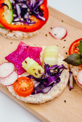 Open sandwiches of rice cakes with cream cheese , vegetables