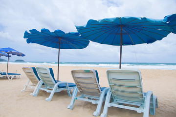 Chair with umbrella in beach summer holiday 