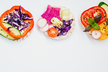 Open sandwiches of rice cakes with cream cheese , vegetables