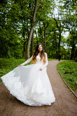 Obraz na płótnie Canvas Sweet bride in the wedding dress is spinning