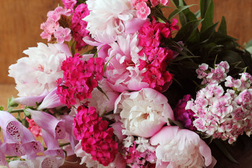 Beautiful summer flowers. Bouquet of pink peony and Dianthus barbatus background