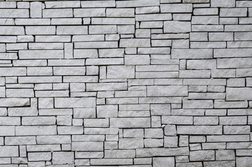 White wall built using irregular cuts bricks