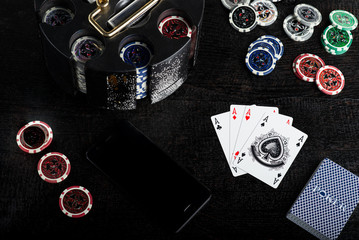 online poker with phone movil smartphone and chips. 4 poker aces advertising image