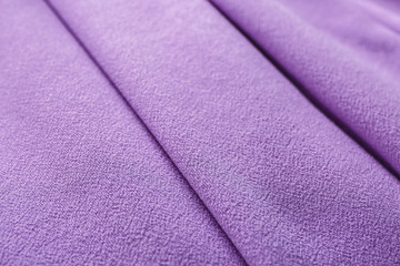 Fototapeta na wymiar Texture of lilac fabric with folds