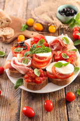 assorted bruschetta with tomato, mozzarella, olive