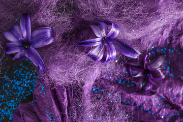 Purple flowers with fibers and paper, closeup